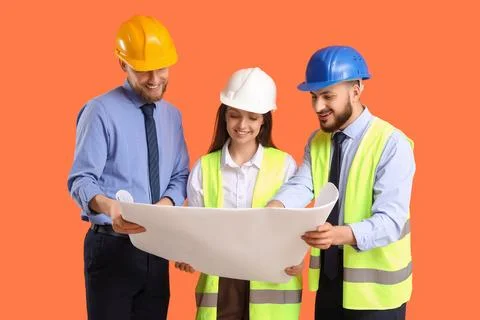 Group of engineers with house plan on orange background Stock Photos