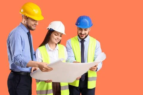 Group of engineers with house plan on orange background Stock Photos