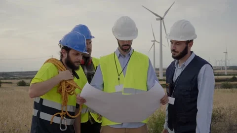 Group of engineers talking and working with a blueprint in an agricultural field Stock Footage 219547875