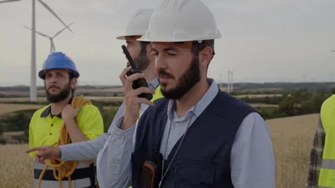 Group of engineers from wind power plant walking together for maintenance of Stock Footage 256092127