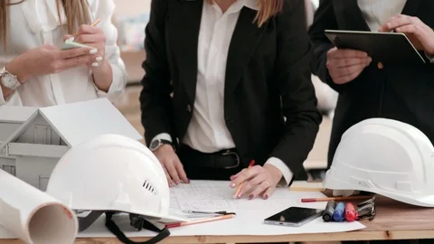 A group of engineers work in an office with a house plan. hold a digital tablet Stock Footage 102550466