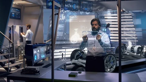 Group of engineers working on holographic design of electric car concept Stock Footage 119667978