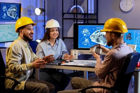 Group of engineers working in office at night Stock Photos