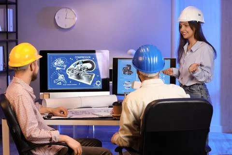 Group of engineers working in office at night, back view Stock Photos