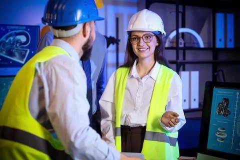 Group of engineers working in office at night Stock Photos
