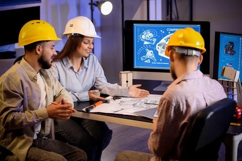 Group of engineers working in office at night Stock Photos