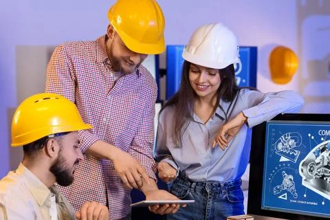 Group of engineers working with tablet computer in office at night Stock Photos