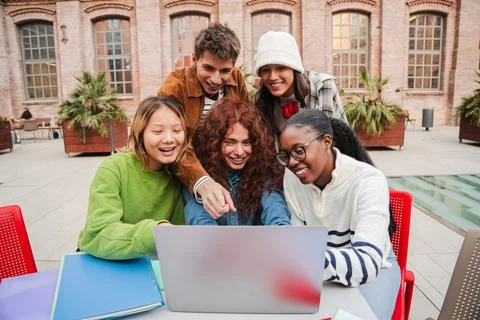 Group of enthusiastic students collaborating on a project while gathered on.. Stock Photos
