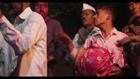 A group of ethnic men dancing and plying instruments in a village ritual Stock Footage 316294940