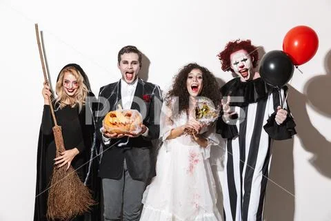 Group of excited friends dressed in scary costumes Stock Photos