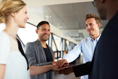 Group of executives with hands together Stock Photos