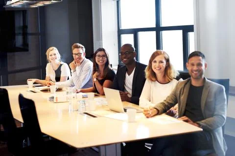 Group of executives smiling for camera Stock Photos