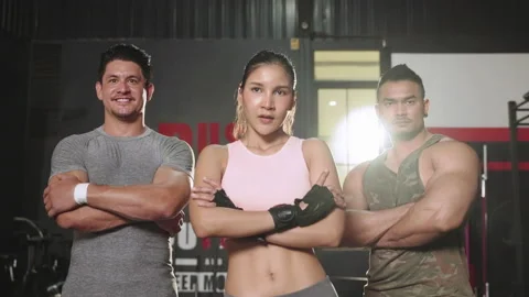 Group of exercisers standing with Crossed arms in the gym Stock Footage 154187701