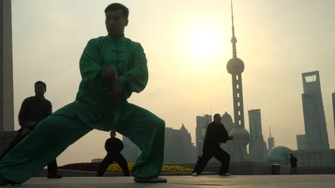 Group exercising with Tai Chi on The Bund, Shanghai, China Stock Footage 69936282