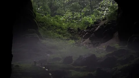Group of explorers walking up hill to the jungle inside Son Doong cave Stock Footage 341298260