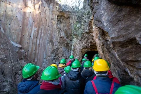 Group exploring a cave with safety helmets Stock Photos