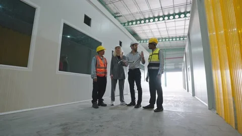Group of factory warehouse workers standing and talking in warehouse for work Stock-Footage 238732919