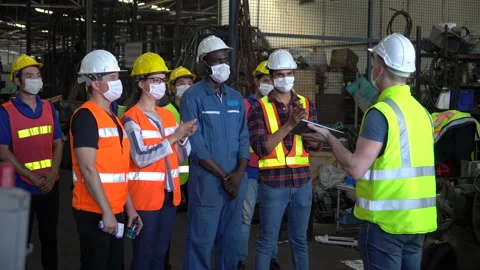 Group of factory workers wear protective face mask meeting in industrial fact Stock Footage 139097133