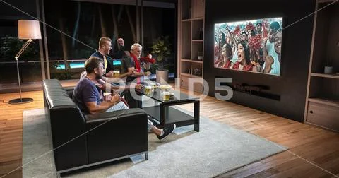 Group of fans are watching a soccer moment on the TV. Stock Photos