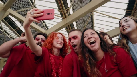 Group of fans take selfie while cheering for their sports team from a stadium Stock Footage 156992733