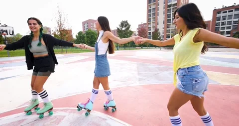 Group of female friends dancing in circle on roller blades Stock Footage 220333239