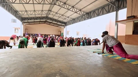 A group of female students practicing Yoga at school auditorium Stock Footage 229867073