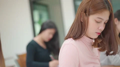 A group of female students sitting in a class and taking exams in a classroom Video stock 147957057