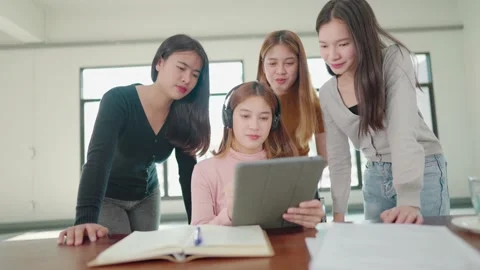 A group of female students sitting in a class and taking exams in a classroom Stock Footage 147957205