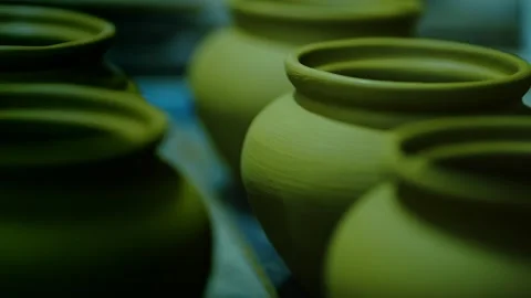 Group of finished raw clay pots drying in a traditional pottery workshop. Stock Footage 328925507