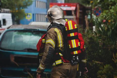 Group of fire men in protective uniform during fire fighting operation in t.. Stock Photos