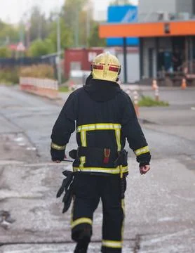 Group of fire men in protective uniform during fire fighting operation in t.. Stock Photos