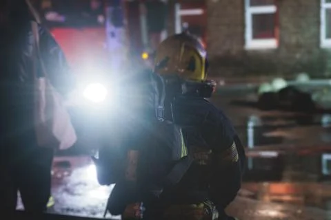 Group of fire men in protective uniform during fire fighting operation in t.. 스톡 사진