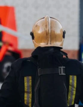 Group of fire men in uniform during fire fighting operation in the city str.. Stock Photos
