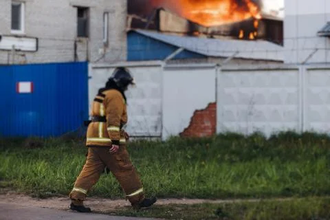 Group of fire men in uniform during fire fighting operation in the city str.. Stock Photos