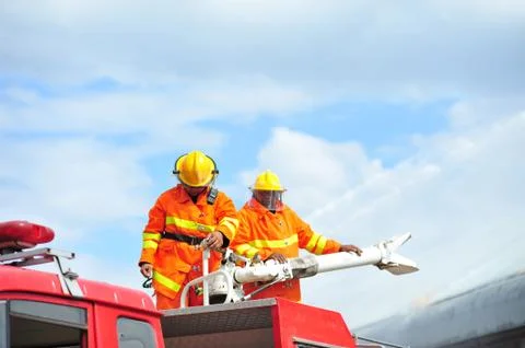 Group of firefighters man are inject spray the water to fire accident on bu.. Stock Photos