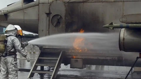Group of firefighters putting out the fire of a aircraft during training Stock Footage 101029448