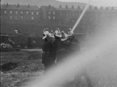 Group of fireman performing training on railway tracks, United Kingdom, 1902 Stock Footage 136822459