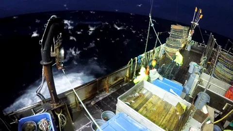 Group of fisherman preparing nets on ship during sea storm, United States Video stock 138891997