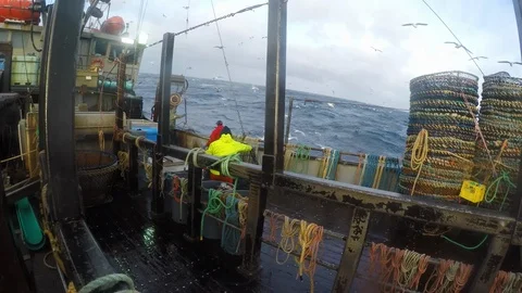 Group of fisherman preparing nets on ship with big waves on sea, United States Video stock 138892154