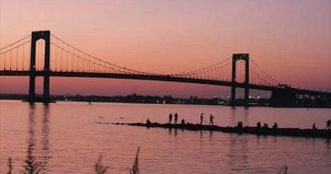 Group of Fishermen Casting Off Rocks Against Sunset Stock Footage 263373801