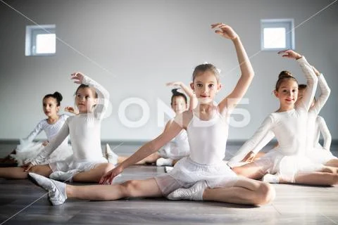 Group of fit happy children exercising ballet in studio together Stock Photos