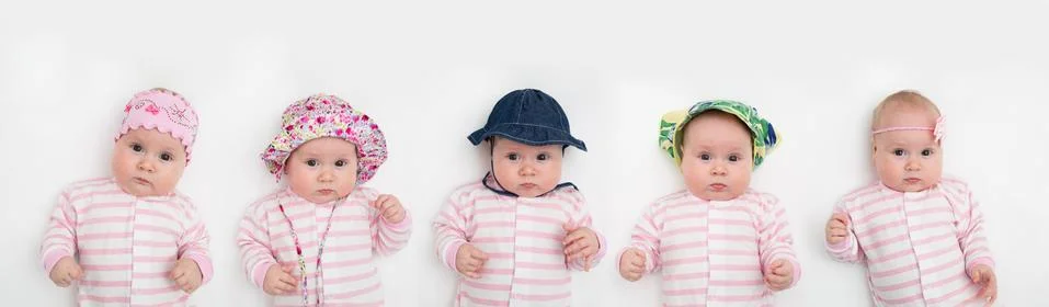 Group of five cute babies, 3 months old, in different summer hat Stock Photos