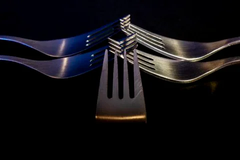 Group of five forks facing each other. Stock Photos