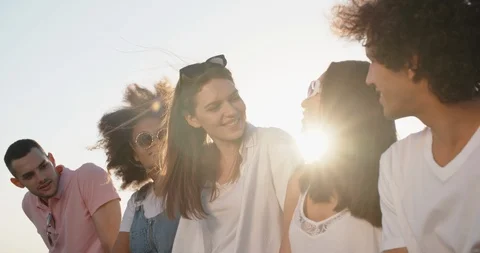 Group of five multiethnic friends hanging out on summer rooftop party, talking Stock-Footage 94709776