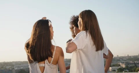Group of five multiethnic friends hanging out on summer rooftop party, talking Stock Footage 96417535