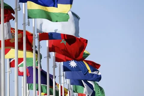 Group of flags of many different nations against blue sky during expo Stock Photos