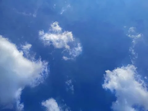 Group of Fluffy Clouds on Blue Sky Stock Photos