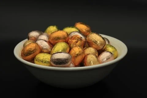 A group of foil wrapped chocolate easter eggs in rainbow colors Stock Photos