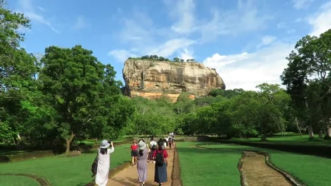A group of foreigners are walking towards sigiriya and taking photographs. Stock Footage 162147232