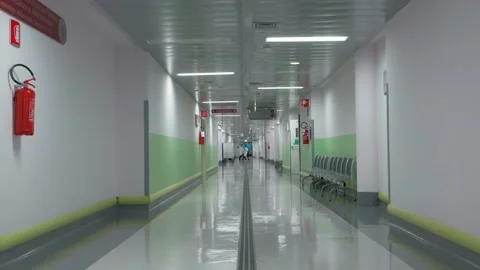 A group of four doctors passing at the very end of a hospital corridor Stock Footage 171588522